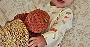 Sophia is registered to the contest to win money with this photo: baby, bed, blue_eyes, child, crib, crocheted_turtle, cute, furniture, happy, indoor, infant, laying_down, nike, onesie, patterned_sheet, plush_toy, sleepwear, smiling, soft_toy, toy