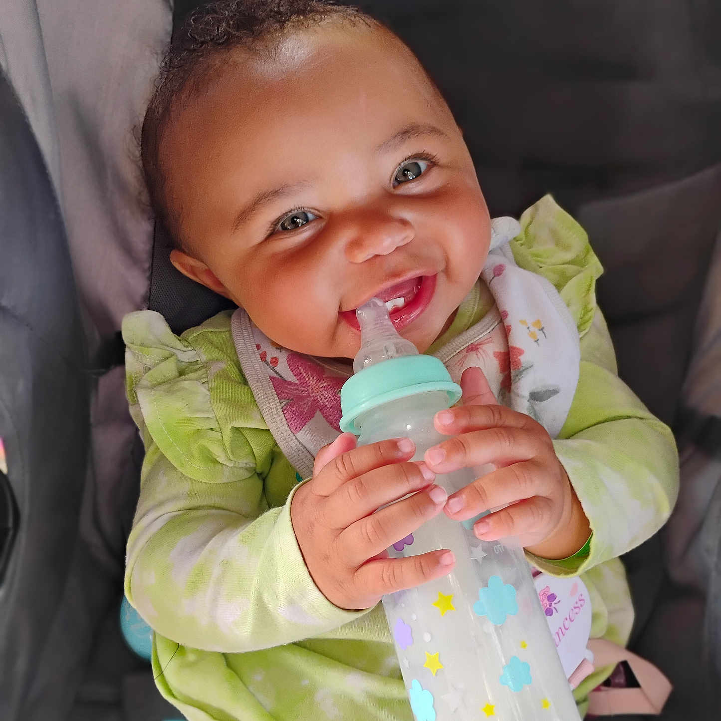 Amirah is registered to the contest to win money with this photo: baby, beverage, biting, bodypart, bottle, couch, drinking, eating, face, finger, food, furniture, hand, happy, head, person, photography, portrait, smile, waterbottle