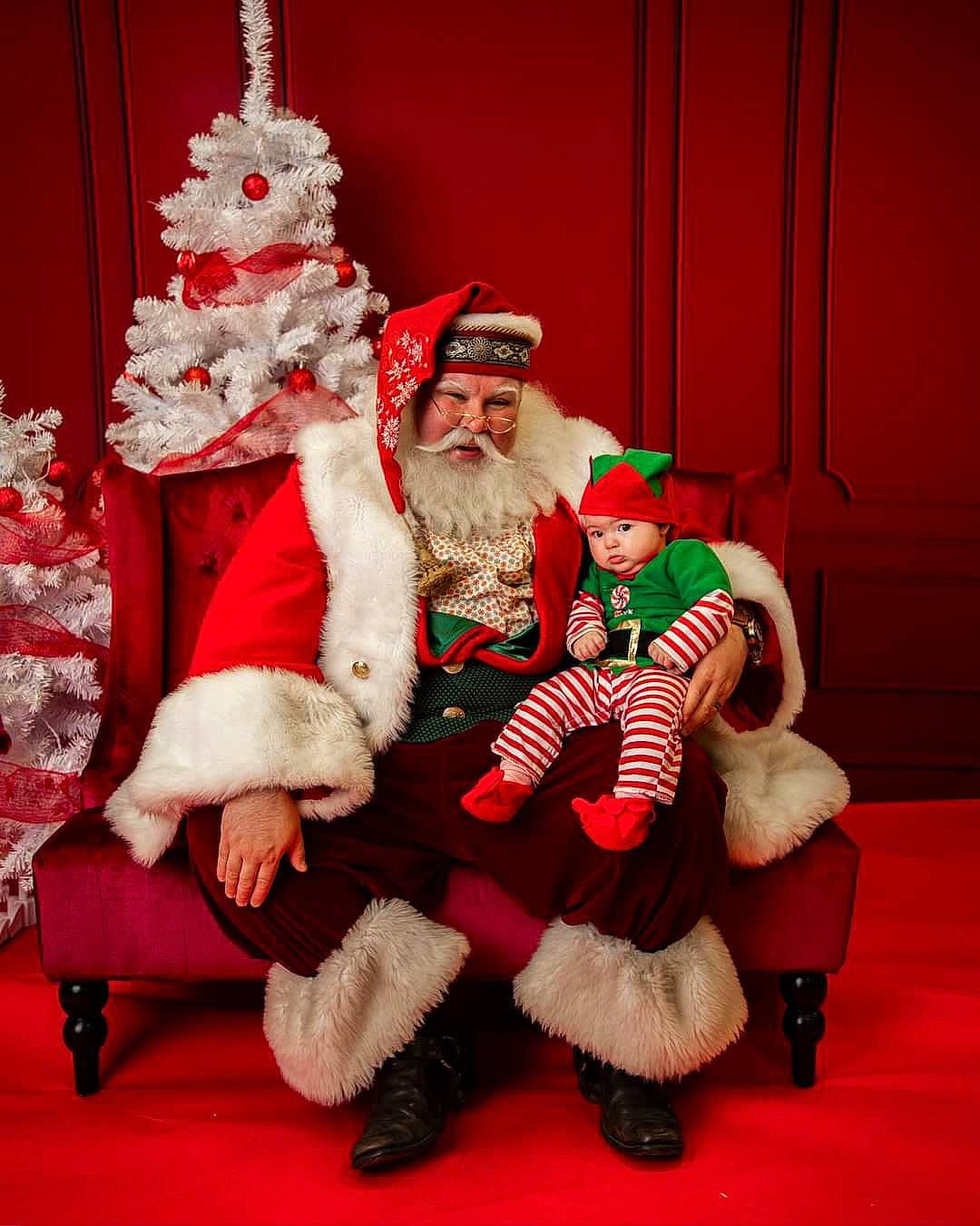 Sadie is registered to the contest to win money with this photo: beard, christmas_decoration, christmas_eve, christmas_ornament, christmas_tree, costume_hat, event, fictional_character, fun, fur, happy, hat, headwear, holiday, holiday_ornament, human_body, lap, person, red, santa_claus