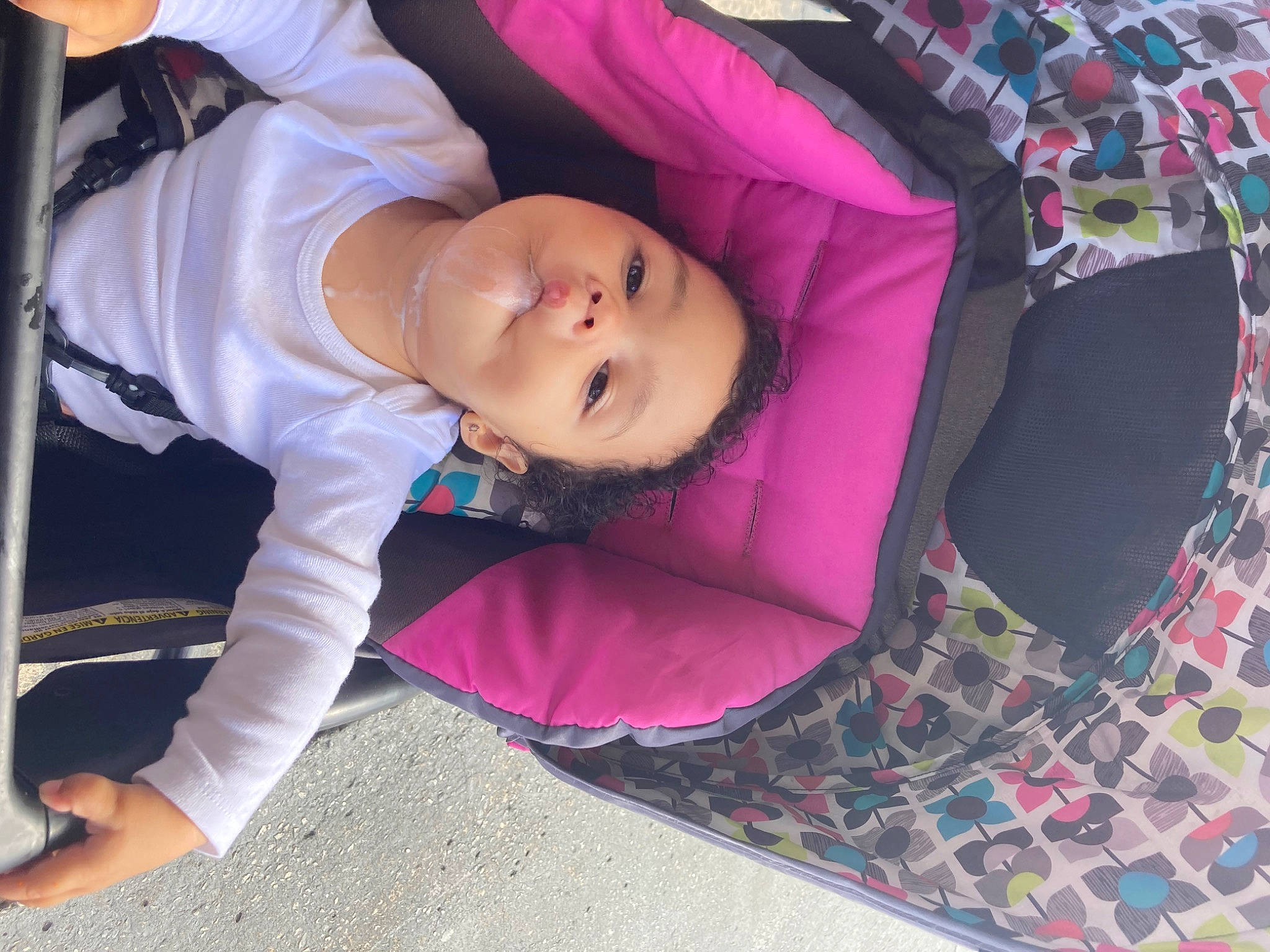 Maliki is registered to the contest to win money with this photo: baby, baby_toddler_clothing, child, comfort, leisure, linens, magenta, pattern, person, pink, plaid, purple, sitting, sleeve, smile, tartan, textile, thigh, toddler, tree