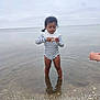 Lana participe au concours pour gagner de l'argent avec cette photo : beach, calm, child, cloudy_sky, curious, focus, nature, outdoor, pebble, person, play, reflection, sea, shell, shore, small_object, standing, striped_clothing, toddler, water