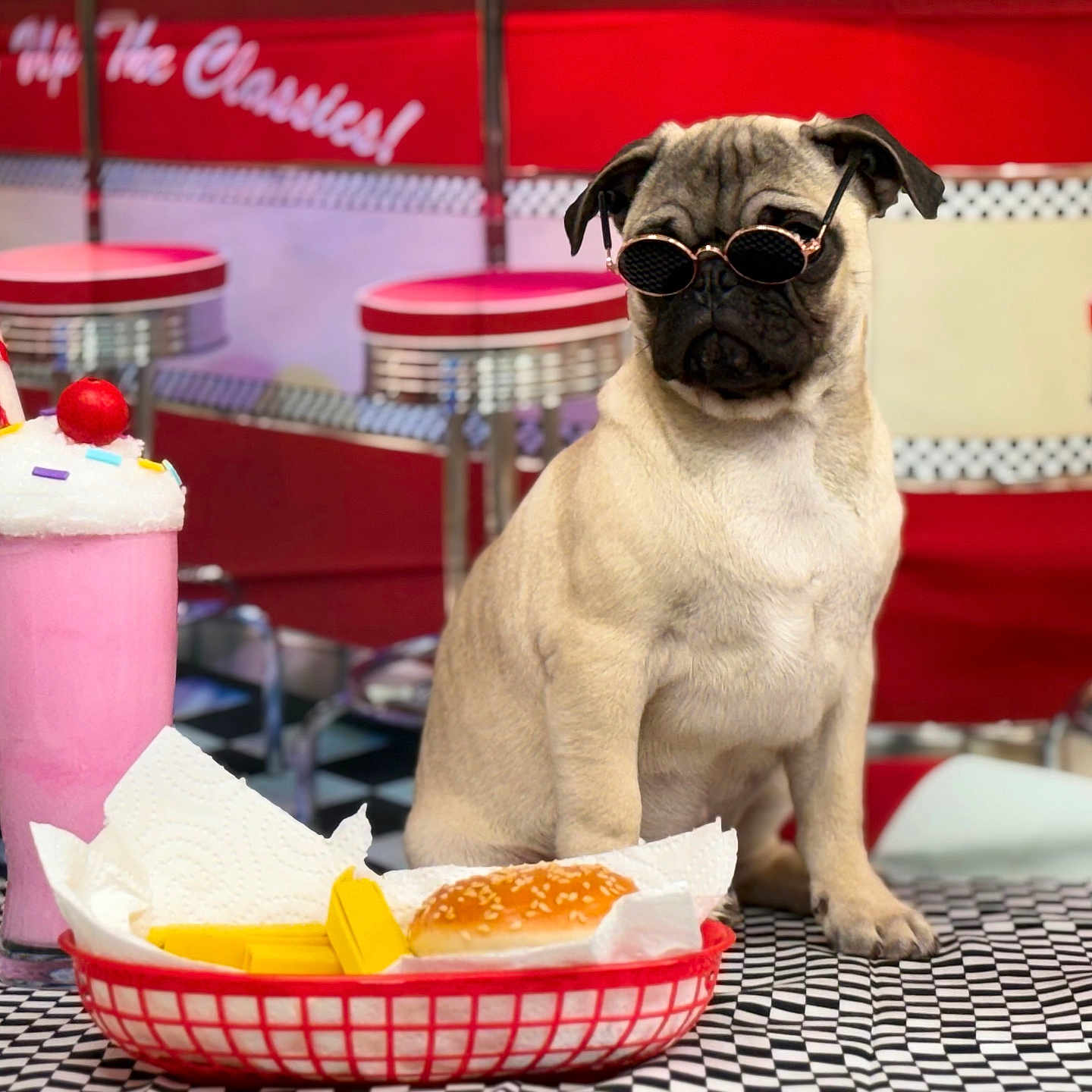Pedrito Ceviche is registered to the contest to win money with this photo: basket, burger, checkered_floor, cherry, diner, dog, food, fries, indoor, ketchup_bottle, milkshake, paper_napkin, pug, red, retro, stool, sunglasses, table, vintage, whipped_cream