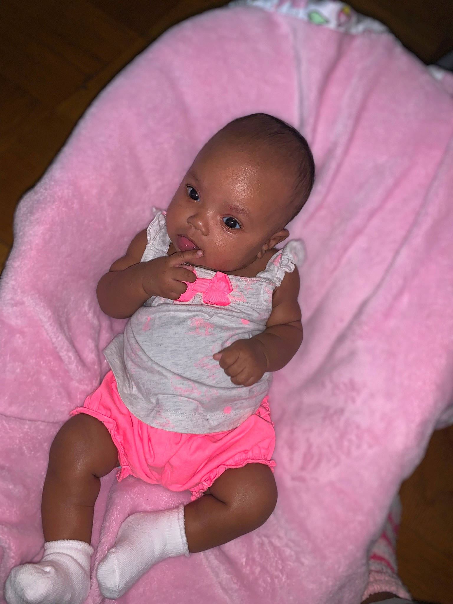 Ailani is registered to the contest to win money with this photo: baby, baby_toddler_clothing, cheek, chin, comfort, eye, finger, hairstyle, head, human_body, iris, leg, lip, mouth, nose, person, pink, purple, skin, sleeve