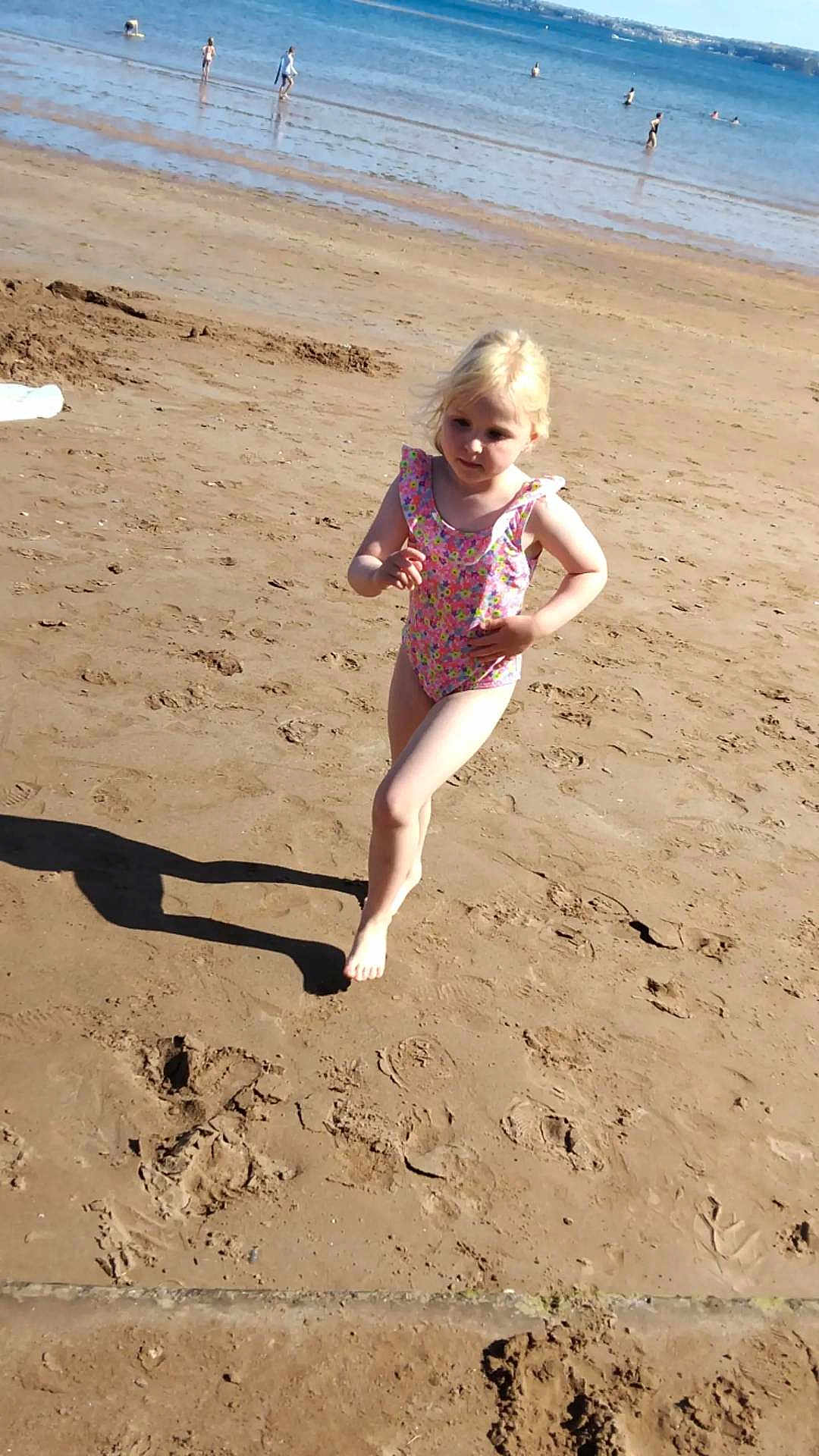 Kiara joined the competition — help win amazing prizes! child, beach, sand, water, ocean, swimsuit, barefoot, sunny, shadow, running, summer, recreation, outdoor, people, shoreline, play, vacation, holiday, fun, coast