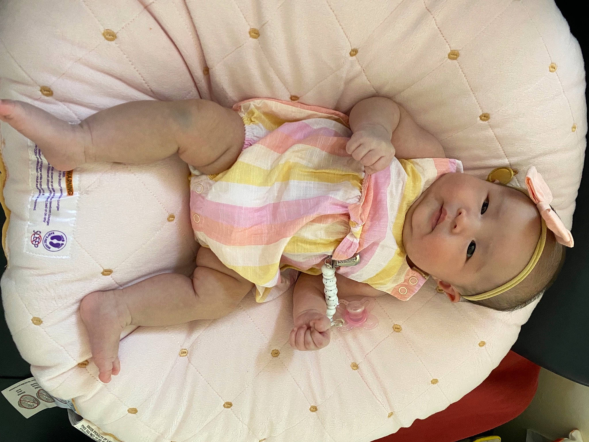 Kailey is registered to the contest to win money with this photo: baby, baby_products, baby_safety, baby_toddler_clothing, child, comfort, eye, happy, hat, head, headwear, human_body, pattern, peach, person, pink, product, skin, smile, thumb