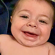 Benjamin is registered to the contest to win money with this photo: baby, infant, child, smile, grin, bare_chest, closeup, portrait, towel, skin, cheeks, eyes, mouth, teeth, happy, sitting, indoors, head, shoulders, cute