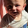 John is registered to the contest to win money with this photo: toddler, child, smiling, curly_hair, blonde, striped_shirt, thumbs_up, sunlight, indoor, portrait, happy, baby, face, clothing, person, cute, young_child, casual, curtain, blue_pocket