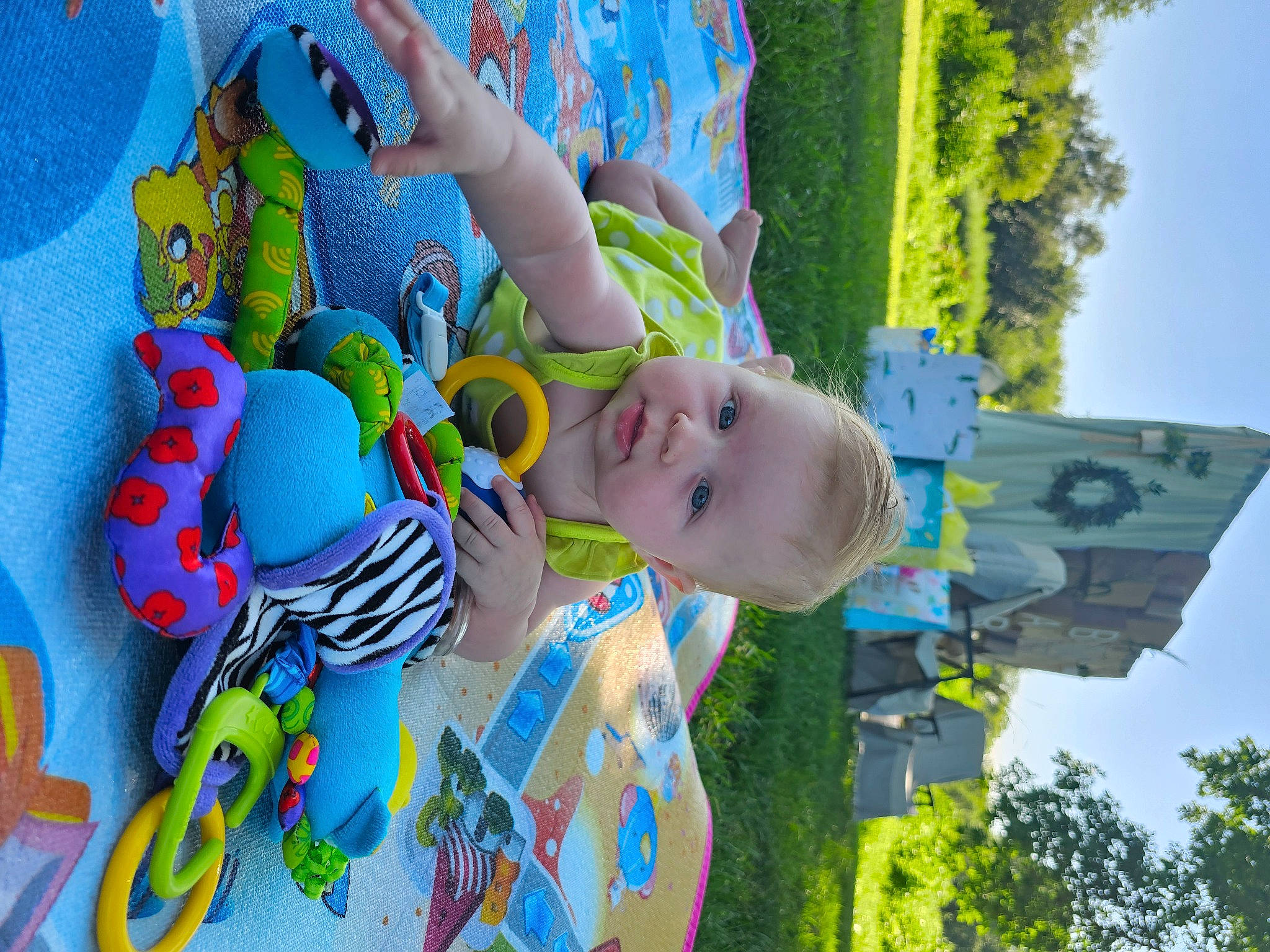 Jane is registered to the contest to win money with this photo: baby, baby_products, blue, child, fictional_character, fun, grass, happy, leisure, person, plant, play, recreation, sky, sunglasses, toddler, toy, tree, vacation, visual_arts