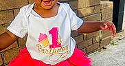 Dawn joined the competition — help win amazing prizes! child, toddler, birthday, pink_tutu, headband, happy, outdoor, brick_wall, sidewalk, white_shoes, smiling, cute, celebration, person, young_child, sunlight, fashion, playful, festive, one_year_old