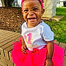 Dawn is registered to the contest to win money with this photo: toddler, child, smile, happy, outdoor, birthday, pink_tutu, headband, brick_wall, grass, sunlight, celebration, cute, young_child, clothing, footwear, sitting, portrait, person, playful