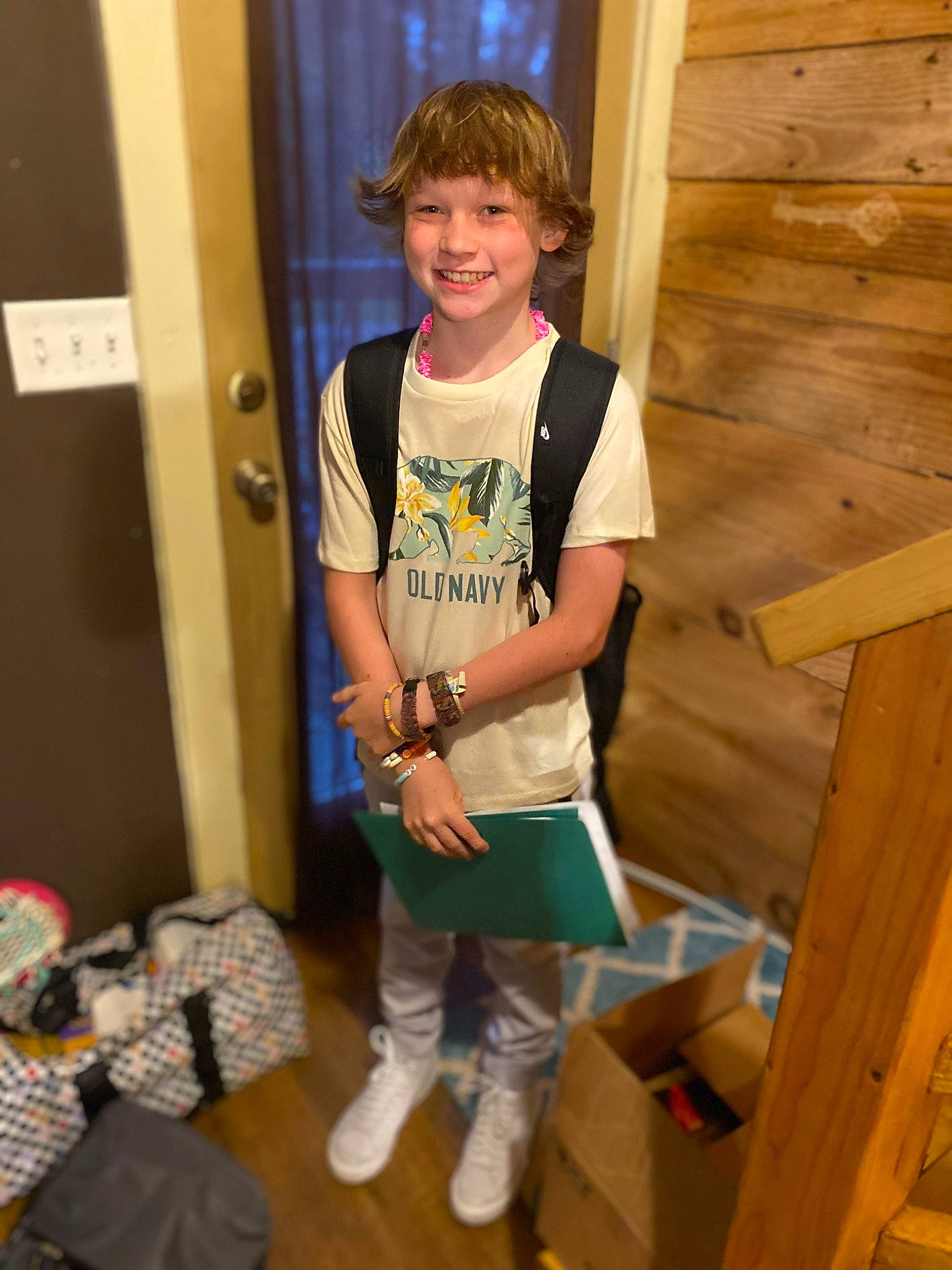 Braxton is registered to the contest to win money with this photo: child, elbow, flooring, fun, hardwood, joy, knee, pattern, person, plank, room, shorts, sleeve, smile, standing, t_shirt, thigh, toddler, varnish, wood