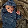 Carson joined the competition — help win amazing prizes! baby, child, blue_hoodie, elephant_print, tongue_out, blanket, soft_texture, cute, infant, clothing, hood, lying_down, playful, expression, indoor, cozy, young_child, person, face, apparel