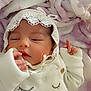 adorable, baby, baby_clothes, blanket, child, cozy, cute, face, hand, indoors, infant, lace_bonnet, newborn, peaceful, pink_blanket, portrait, resting, sleepy, soft_texture, white_outfit