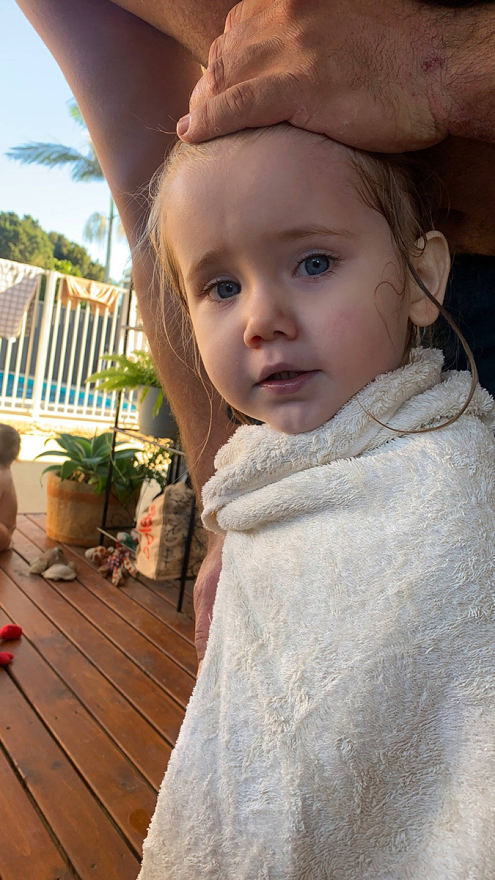 Isla is registered to the contest to win money with this photo: baby, child, flooring, flowerpot, fun, fur, grass, happy, houseplant, leisure, lip, nose, person, plant, sitting, skin, sky, toddler, tree, wood