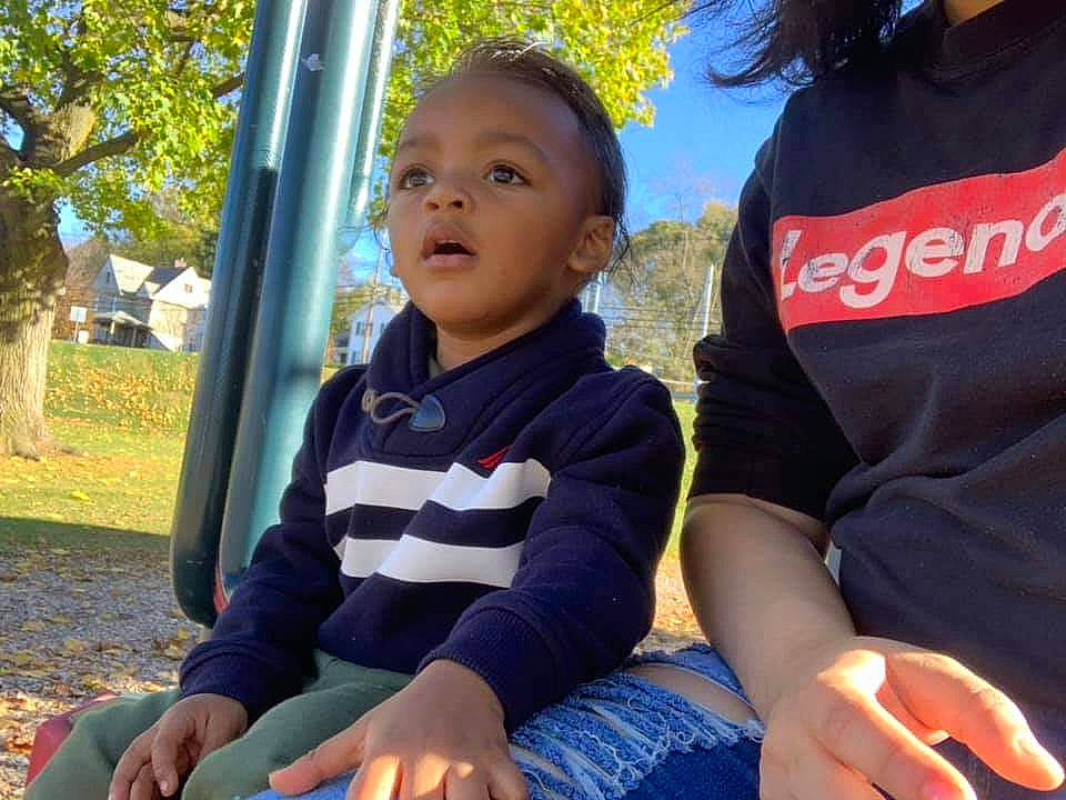 Prince is registered to the contest to win money with this photo: baby, child, community, fun, happy, leisure, outdoor_play_equipment, person, plant, play, playground, public_space, recreation, sitting, smile, toddler, tree, vacation