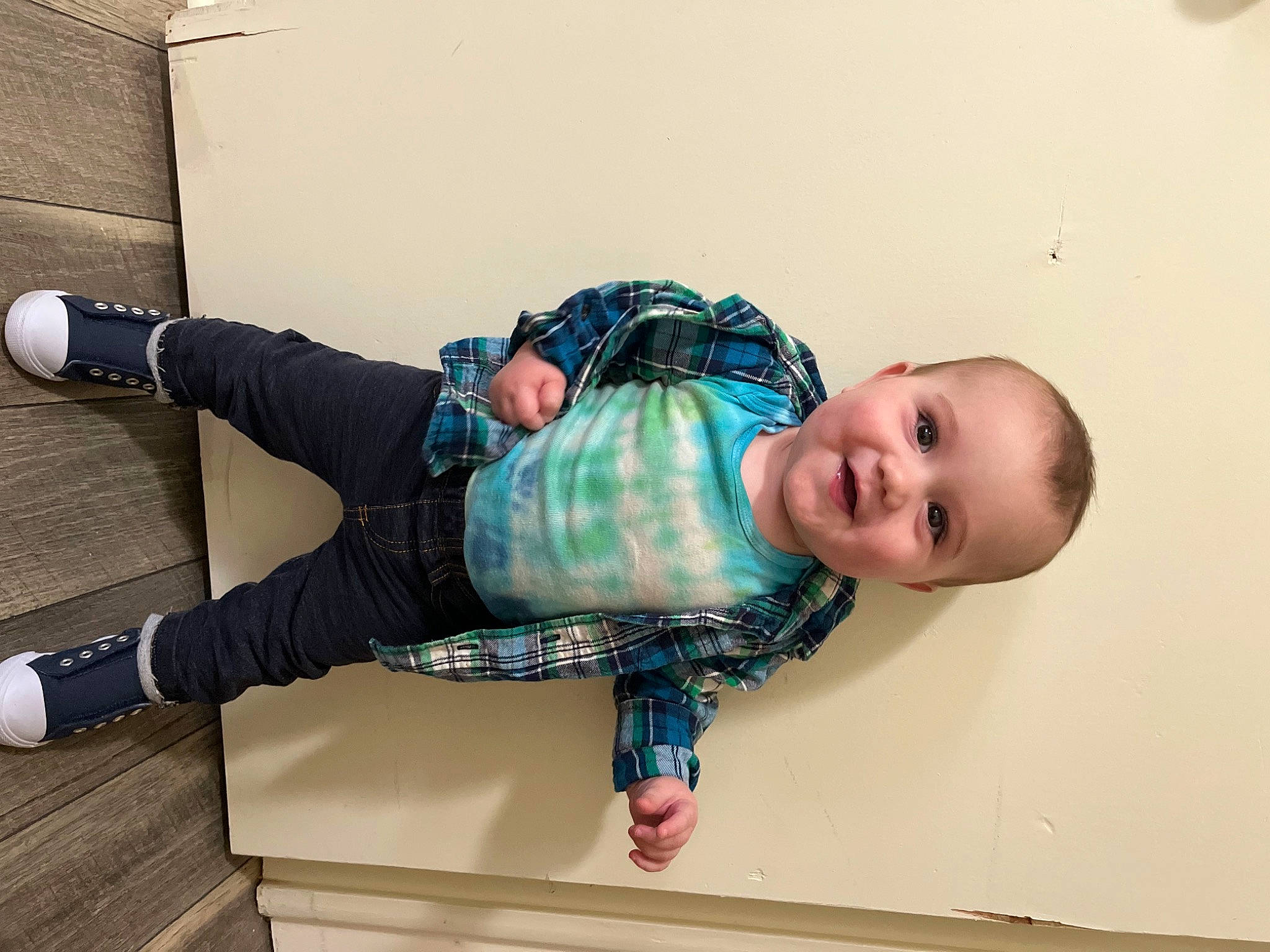 Jaxxon is registered to the contest to win money with this photo: arm, baby, baby_toddler_clothing, child, comfort, flooring, fun, happy, joint, joy, knee, pattern, person, plaid, sitting, sleeve, smile, sock, street_fashion, thigh
