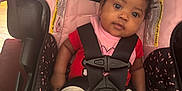 Jamaya joined the competition — help win amazing prizes! baby, car_seat, infant, child, red_bow, pink, black, seatbelt, strapped, wide_eyes, looking, indoors, clothing, socks, legs, face, head, cute, safety, person