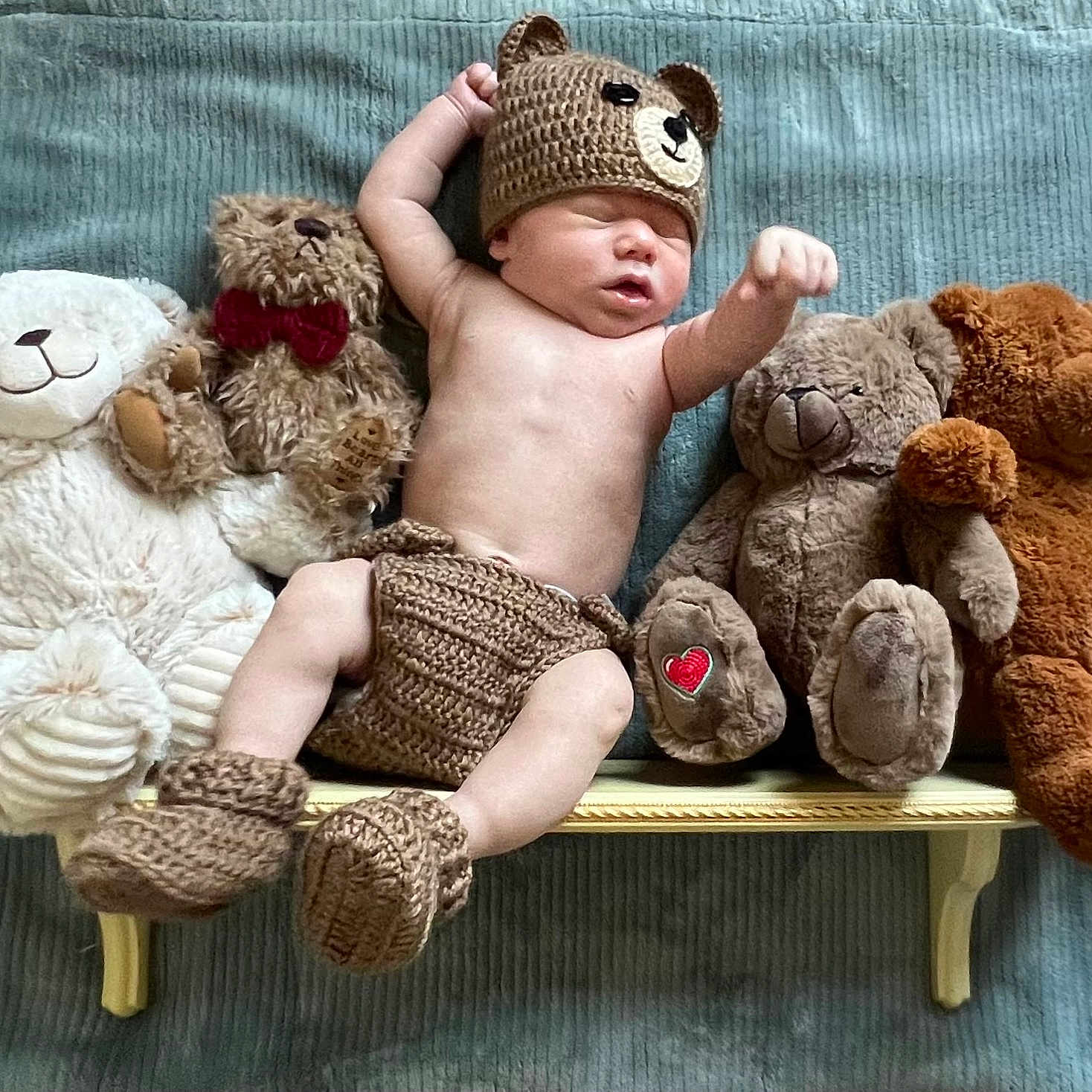 Coltlon is registered to the contest to win money with this photo: baby, bear_booties, bear_hat, bench, blanket, child, cozy, cute, indoor, infant, knitted_clothing, nursery, peaceful, plush_toys, portrait, resting, sleeping, soft_toys, teddy_bears, toy_collection