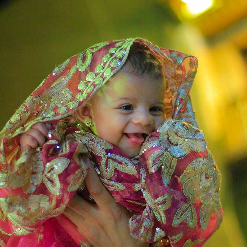 Waad joined the competition — help win amazing prizes! baby, bright, celebration, child, closeup, cute, embroidered_fabric, face, golden_embroidery, hand, happy, holding, indoors, infant, person, pink_clothing, portrait, smiling, traditional_clothing, warm_lighting