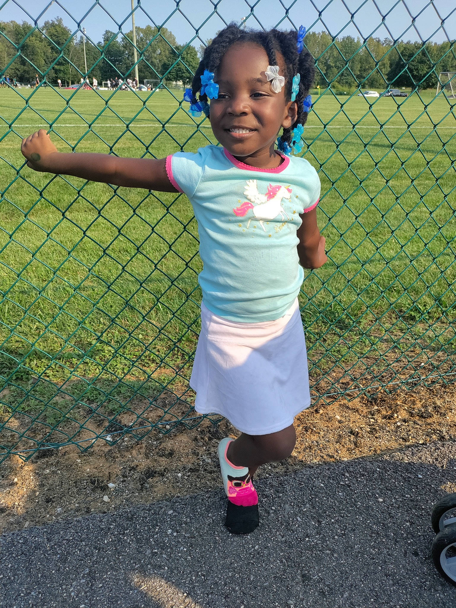 Gionna joined the competition — help win amazing prizes! black, chain_link_fencing, electric_blue, eye, face, fence, fun, grass, head, joy, leisure, mesh, net, people_in_nature, person, player, shorts, sky, sports_equipment, toddler