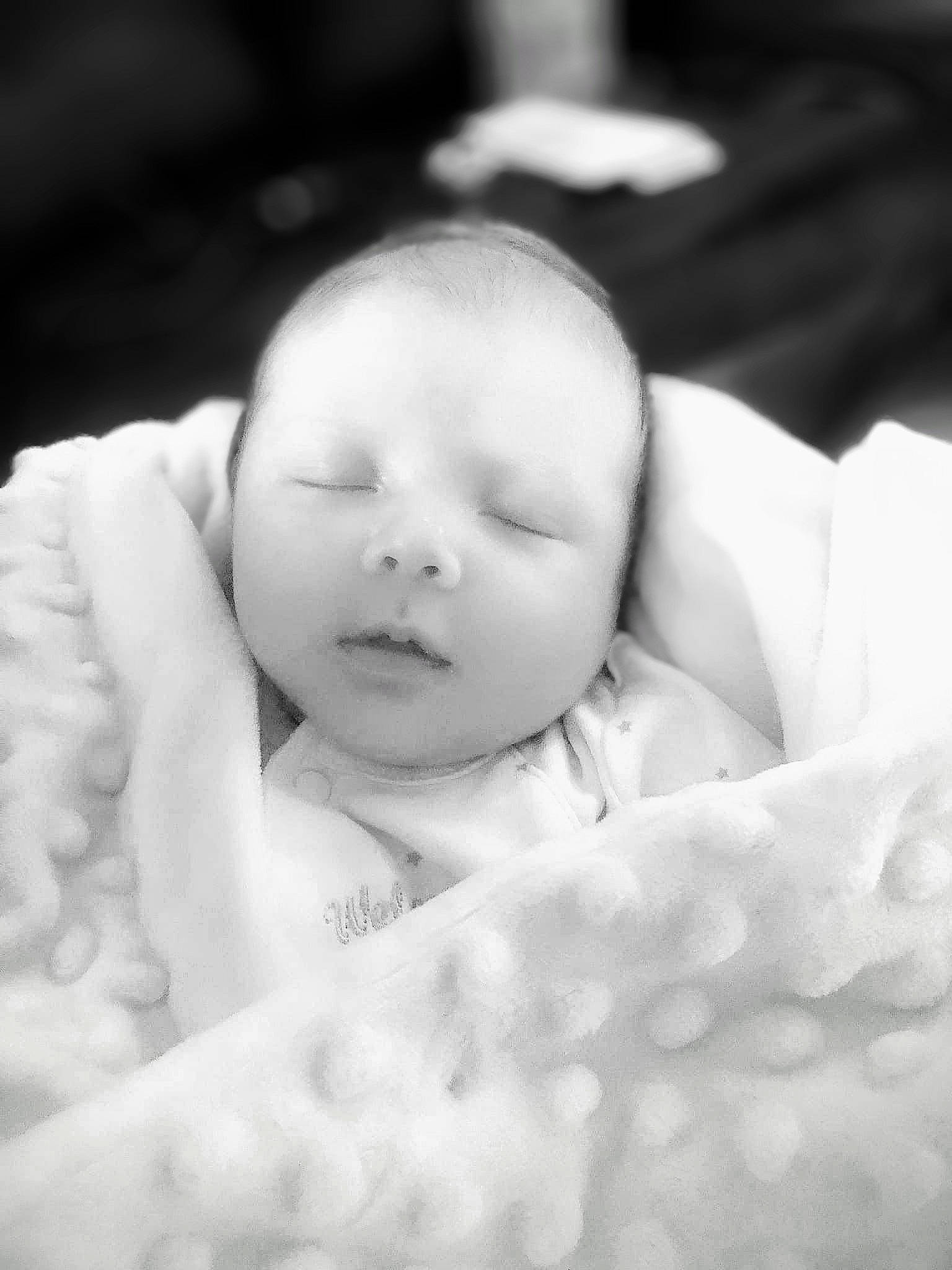 Harry is registered to the contest to win money with this photo: baby, baby_toddler_clothing, cheek, child, close_up, comfort, eye, eyebrow, finger, flash_photography, gesture, happy, iris, lip, monochrome, monochrome_photography, mouth, nose, person, skin