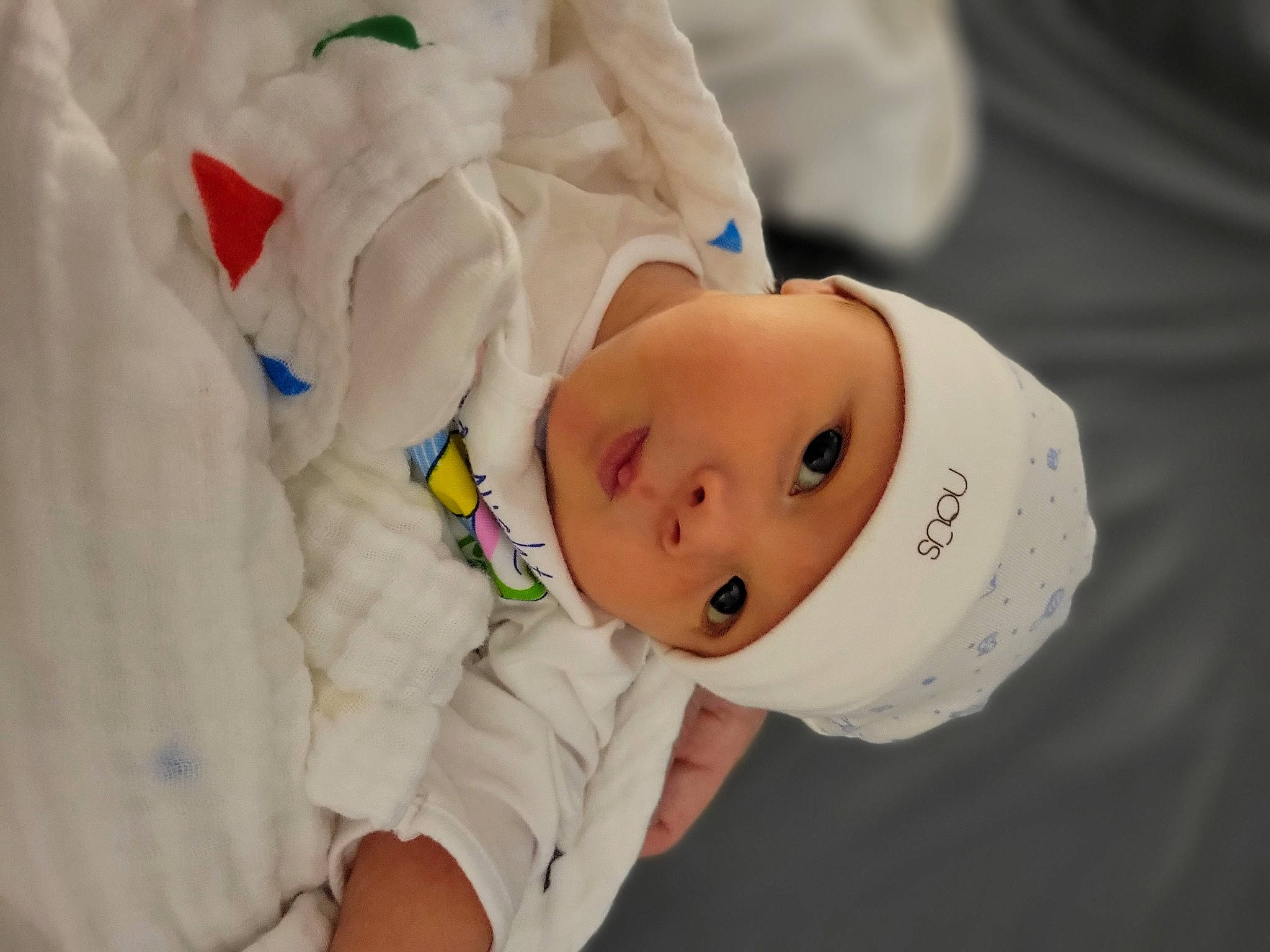 Harry is registered to the contest to win money with this photo: baby, baby_toddler_clothing, child, comfort, elbow, eye, hat, headwear, person, room, skin, sleeve, toddler