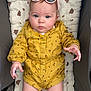 baby, child, infant, romper, yellow_clothing, sunglasses, blue_eyes, padded_seat, cute, portrait, indoor, hand, legs, face, fashion, baby_fashion, expression, young_child, person, comfort