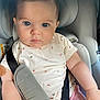 Aprile participe au concours pour gagner de l'argent avec cette photo : baby, child, car_seat, seat_belt, infant, cute, looking_at_camera, clothing, patterned_shirt, pink_pants, safety, indoor, close_up, face, person, young, adorable, serious_expression, head, arm
