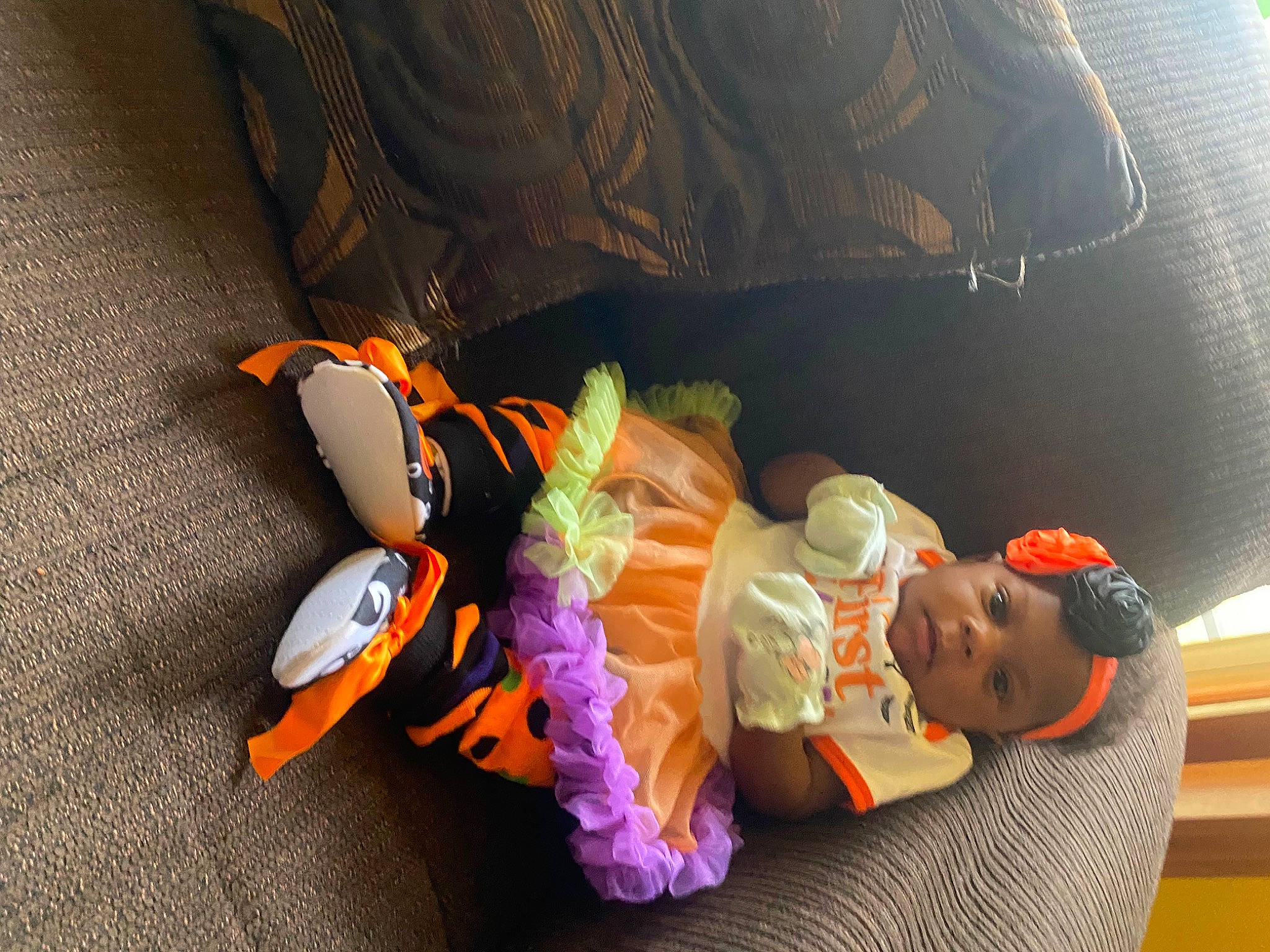 Emani is registered to the contest to win money with this photo: animation, audio_equipment, baby, baby_products, baby_toys, car_seat, child, comfort, family_car, flooring, fun, leisure, orange, person, room, sitting, stuffed_toy, toddler, toy