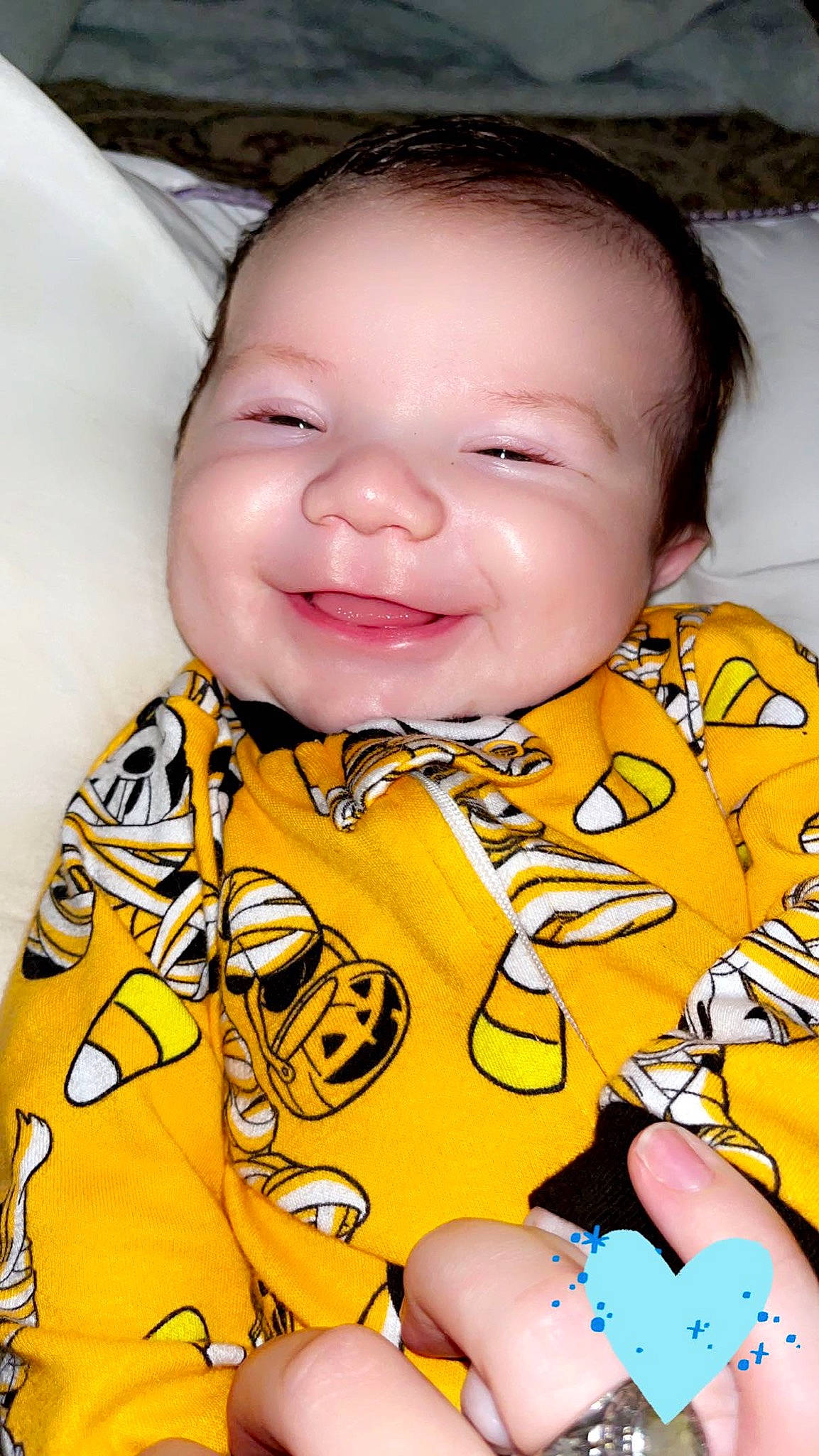 Parker is registered to the contest to win money with this photo: baby_toddler_clothing, cheek, chin, face, facial_expression, finger, happy, head, human_body, joy, mouth, neck, nose, orange, outerwear, person, product, skin, sleeve, smile