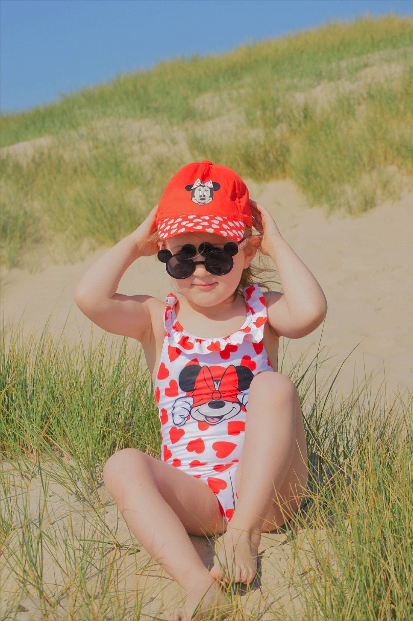 Elsa Et Cyana participe au concours pour gagner de l'argent avec cette photo : baseball_cap, cap, eyewear, fun, glasses, goggles, grass, grassland, hand, happy, headwear, leisure, people_in_nature, person, plant, smile, summer, sunglasses, thigh, toddler