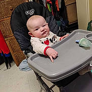 Daryl joined the competition — help win amazing prizes! baby, high_chair, pointing, indoor, child, clothing, face, person, furniture, pacifier, expression, hand, floor, room, drawer, cabinet, toy, sleeve, footwear, looking