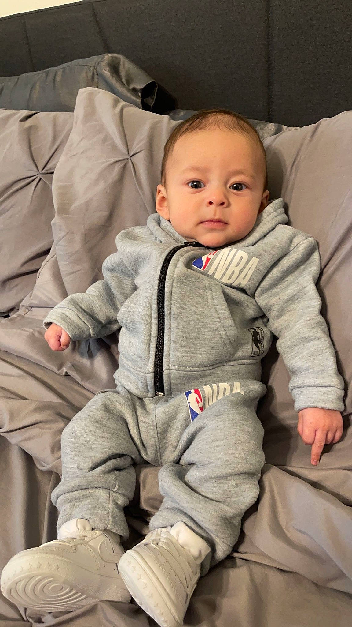 Eliyas joined the competition — help win amazing prizes! baby, baby_toddler_clothing, camouflage, carmine, cheek, child, chin, collar, comfort, face, flooring, gesture, head, outerwear, person, personal_protective_equipment, sitting, skin, sleeve, smile