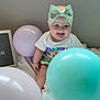 baby, infant, smiling, bow, headband, balloon, pastel_colors, sign, 6_months, sitting, cute, happy, celebration, milestone, clothing, indoors, fabric, child, portrait, person