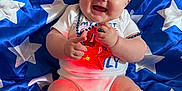 Oaklee Mae joined the competition — help win amazing prizes! baby, smiling, bow, headband, star, blue, blanket, pattern, clothing, necklace, red_light, happy, infant, cute, sitting, chubby, indoor, portrait, child, celebration