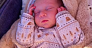 Axel participe au concours pour gagner de l'argent avec cette photo : baby, sleeping, blanket, onesie, patterned_clothing, cozy, infant, child, soft, warm, peaceful, closed_eyes, newborn, cute, bundle, resting, furry_blanket, indoors, stroller, bassinet