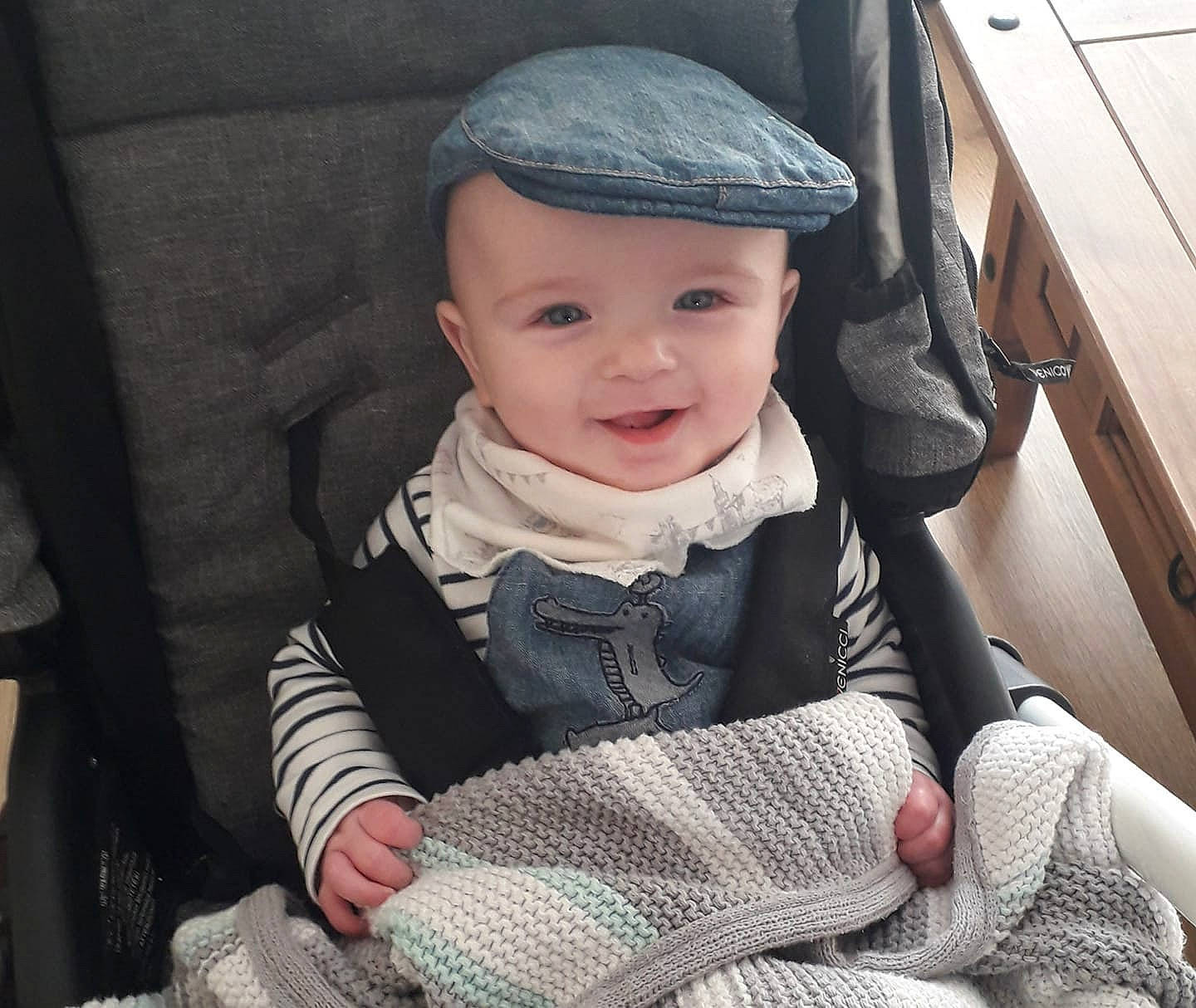 Alfie Jack is registered to the contest to win money with this photo: baby, baby_carriage, baby_products, bonnet, cheek, child, cool, eye, face, hand, head, headgear, headwear, knit_cap, knitting, outerwear, person, product, sitting, skin
