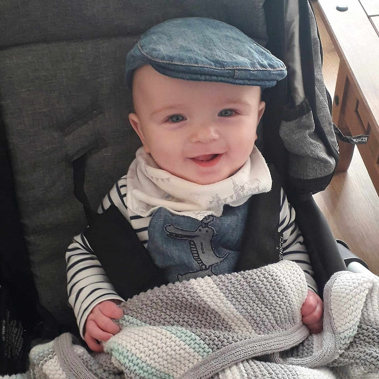 Alfie Jack is registered to the contest to win money with this photo: baby, baby_carriage, baby_products, bonnet, cheek, child, cool, eye, face, hand, head, headgear, headwear, knit_cap, knitting, outerwear, person, product, sitting, skin