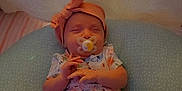 Ka'Lani Grace joined the competition — help win amazing prizes! baby, blue, child, clothing, cozy, cushion, cute, floral_dress, hands, headband, indoors, infant, newborn, nursery, pacifier, peaceful, pink, resting, sleeping, soft_lighting
