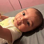 Alberto joined the competition — help win amazing prizes! arm, baby, bed, child, closeup, clothing, cute, expression, eyes, face, gray, indoors, infant, laying_down, onesie, pink_wall, portrait, skin, soft_light, young