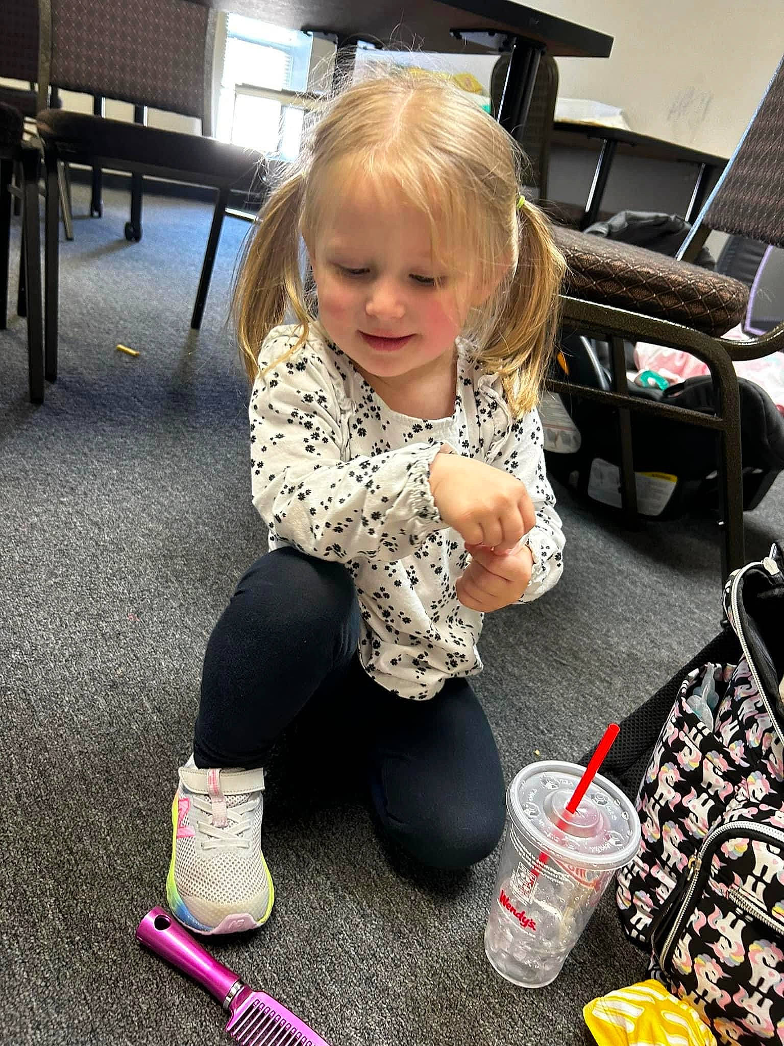 Peyton is registered to the contest to win money with this photo: baby, baby_toddler_clothing, chair, child, clothing, computer_keyboard, floor, flooring, fun, human_leg, knee, lap, pattern, person, shoe, sitting, smile, sneakers, sock, thigh