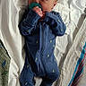 newborn, baby, pacifier, blue_onesie, sleeping, blanket, towel, infant, cozy, bed, resting, cute, small, hands, face, head, person, soft, sleep, child