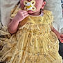 baby, pacifier, yellow_dress, socks, cushion, soft_fabric, infant, hand, face, clothing, cute, newborn, resting, indoor, person, child, portrait, comfort, skin, small