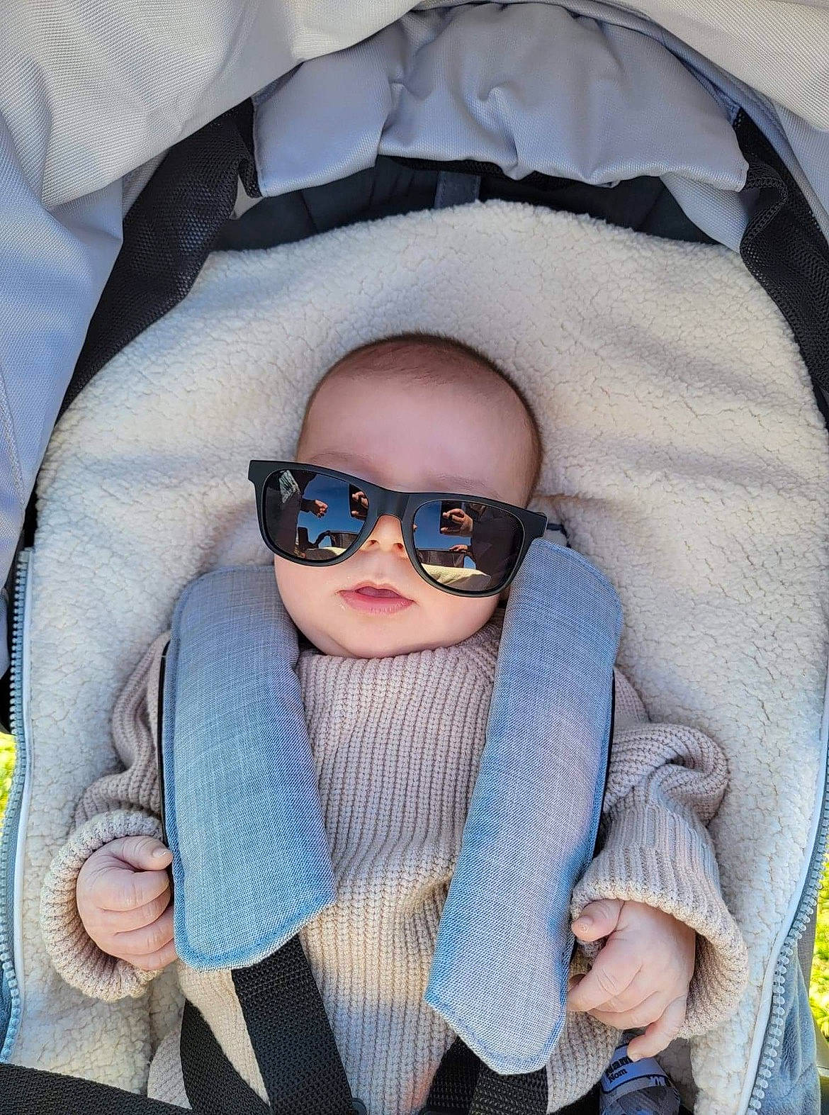 Colin is registered to the contest to win money with this photo: baby, baby_carriage, baby_toddler_clothing, cheek, chin, comfort, eye, eyebrow, eyewear, glasses, goggles, head, headgear, outerwear, person, personal_protective_equipment, product, seat_belt, sunglasses, toddler