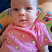 Bukley joined the competition — help win amazing prizes! baby, infant, child, pink_onesie, bee_pattern, blue_eyes, cushion, plush_toy, cute, portrait, indoor, closeup, smiling_bees, clothing, person, face, young_child, soft_toys, colorful, resting
