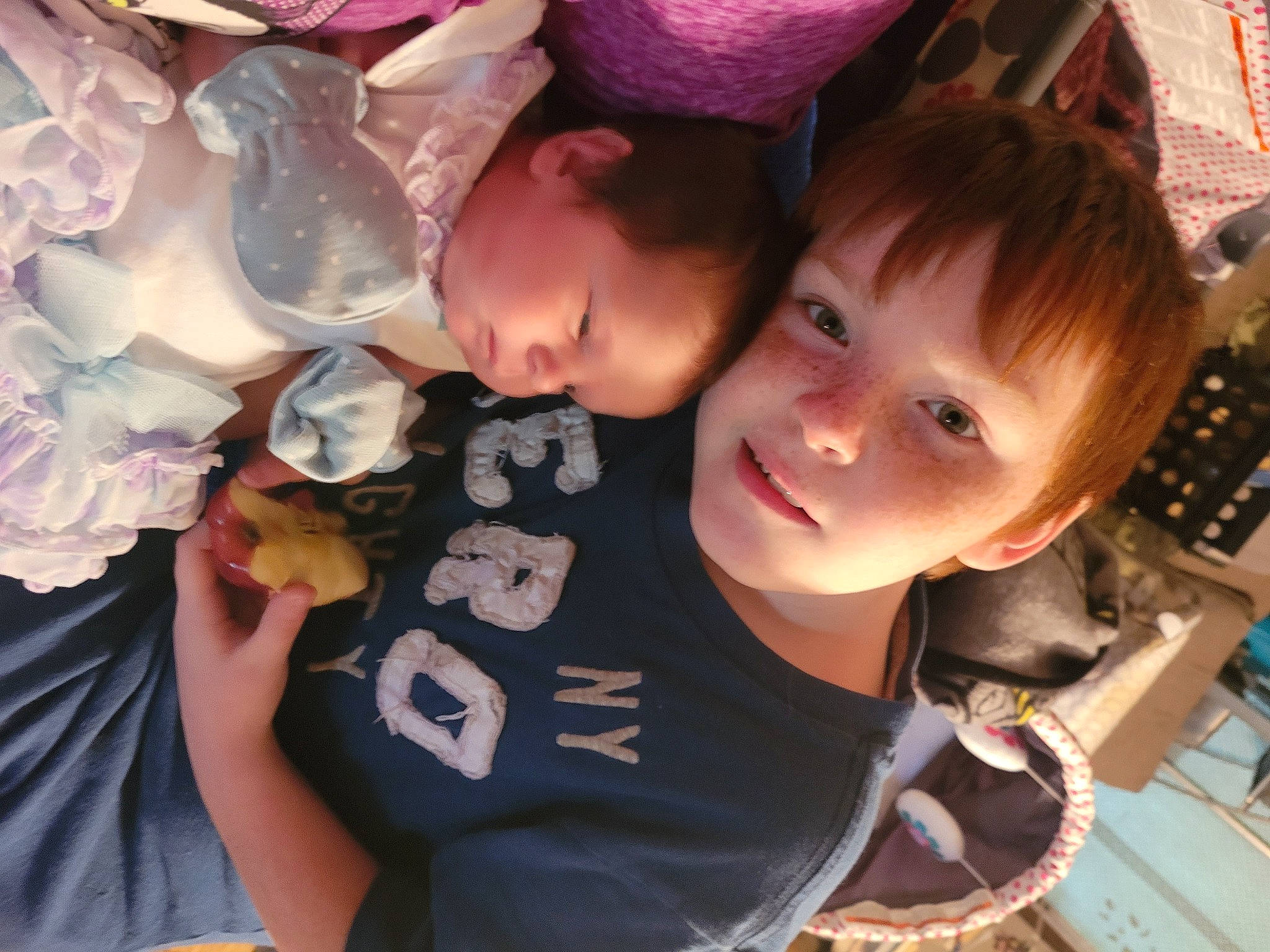 James is registered to the contest to win money with this photo: baby, baby_toddler_clothing, bangs, cheek, child, cool, event, finger, fun, hairstyle, happy, iris, mouth, person, petal, pink, skin, smile, t_shirt, toddler