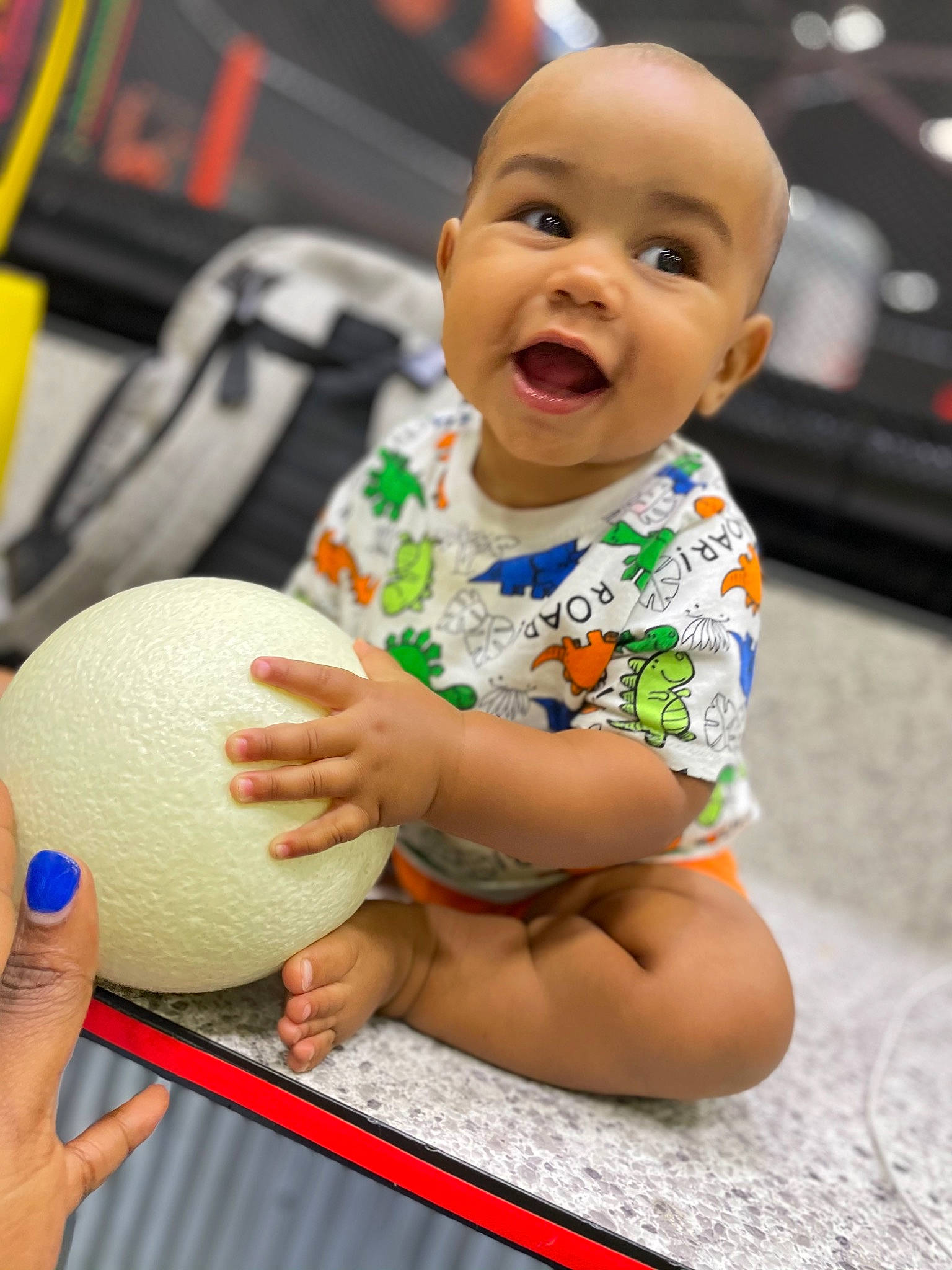 Jamir is registered to the contest to win money with this photo: arm, baby, baby_toddler_clothing, ball, cheek, child, face, finger, football, hand, happy, mammal, person, playing_sports, shorts, smile, soccer_ball, sports_equipment, sports_toy, t_shirt