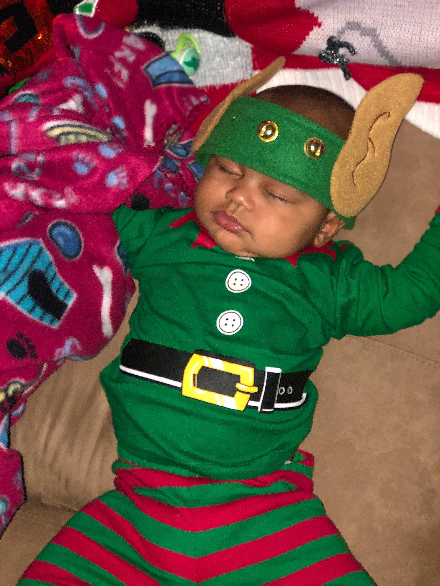 Jamir is registered to the contest to win money with this photo: baby_toddler_clothing, carmine, child, christmas, christmas_ornament, costume, costume_hat, event, fictional_character, fun, green, happy, hat, headwear, holiday, mammal, outerwear, person, red, sleeve