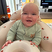 Elliott joined the competition — help win amazing prizes! baby, infant, smiling, face, onesie, bear_patch, inflatable_seat, floral_pattern, hand, living_room, television, furniture, window, daylight, wooden_floor, table, bottle, home, comfort, child