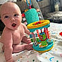 Elliott joined the competition — help win amazing prizes! baby, child, toy, play_mat, indoor, colorful, expression, hand, foot, face, person, couch, blanket, furniture, floor, pattern, curtain, soft_toy, home, infant
